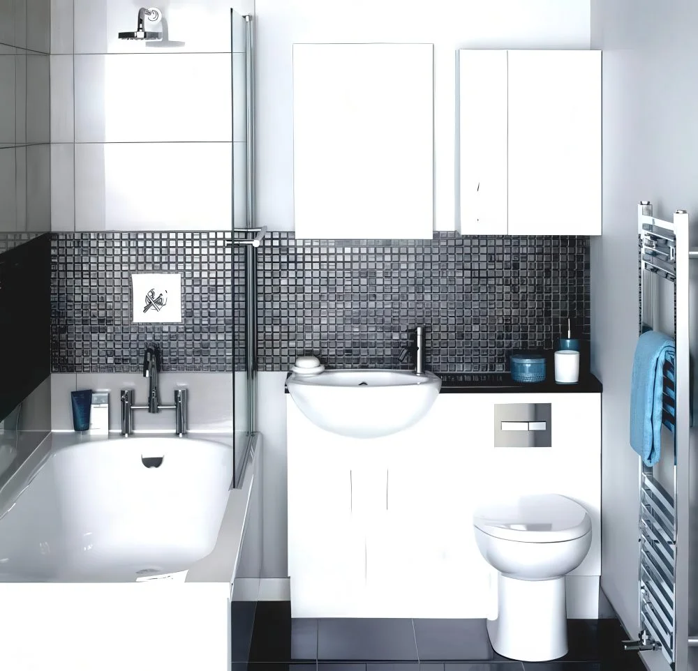 Siyah tezgâh üstüne tasarlanmış lavabo ve tuvalet kombini.