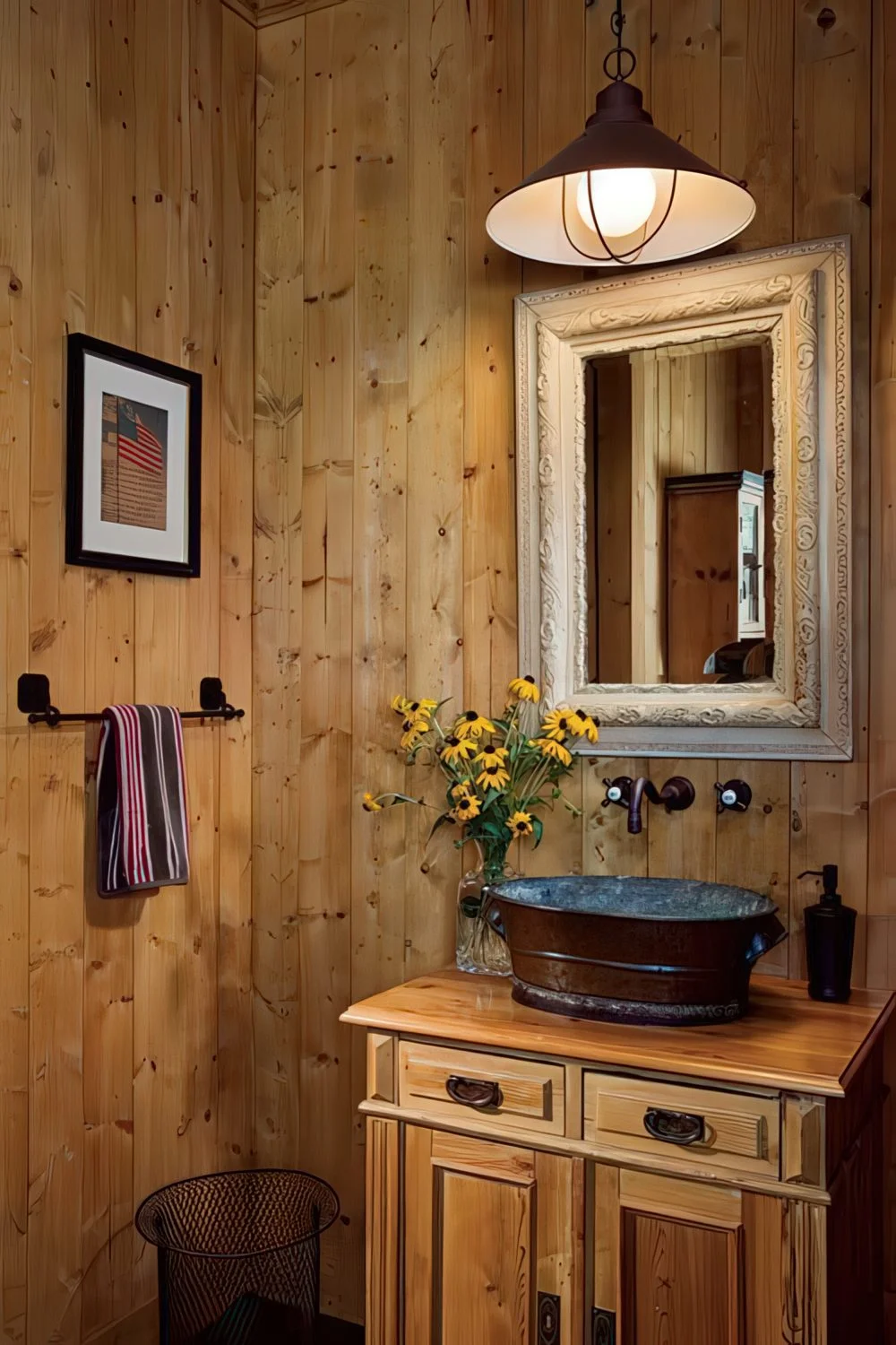 Basit boyalı ahşap banyoda, ahşap lavabo dolabı, çerçeveli ayna ve vintage sarkıt lamba bulunuyor.