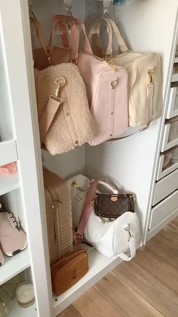 Çantalar gardırobun alt kısmına yerleştirilmiş, büyük parçalar da üstlerindeki kancalara asılmış.