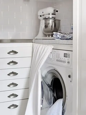 Bir perde, çamaşır makinesi mutfak dolabına tam sığmadığında gizlemek için kullanılabilir.