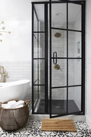 Siyah Fransız kapılar, desenli ve siyah karolar, küvet ve sepetle modern siyah-beyaz banyo.