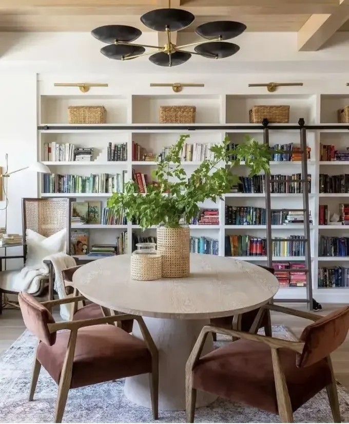 Bu modern çiftlik evi yemek odası, kütüphane merdivenli kitaplıklar etrafında tasarlandı. Pencere kenarında yemek ve okuma köşesi bulunuyor.