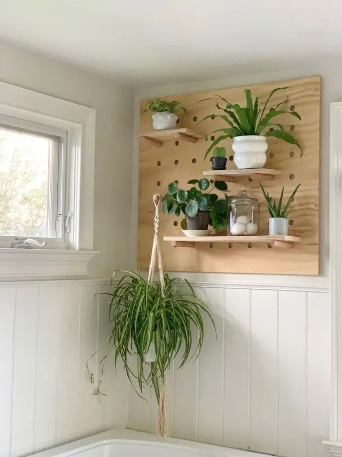 Pegboard, sadece banyo malzemelerini tutmak için değil, aynı zamanda dekorasyon amacıyla da küvetin üzerine takılabilir.