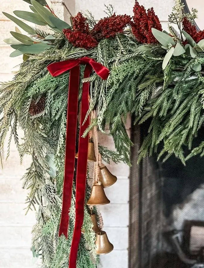 Her türden bol mazı ağacı, kırmızı meyveler, kırmızı kurdele ve vintage zil süsleri, şömine rafı için harika bir kombin; her zaman doğru bir seçim.