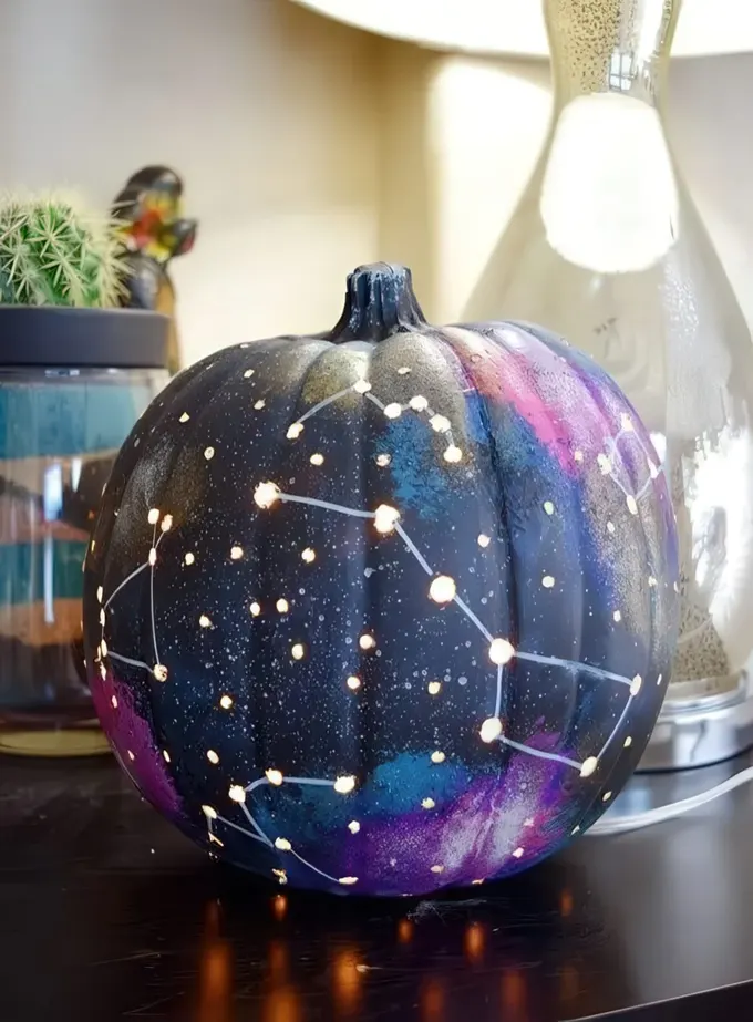 Galaksi desenli balkabağı, gök cisimleri sevenler için özel ve trend bir Halloween dekor fikridir.